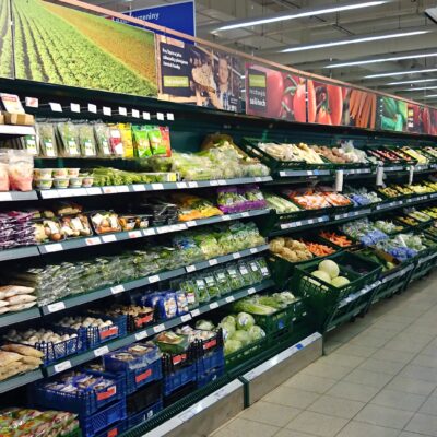Refrigerator full of the vegetables at grocery store.