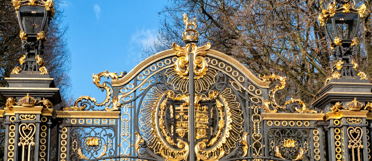 Gate with gilded ornaments in Buckingham Palace. Buckingham Palace is a symbol and home of the British monarchy.